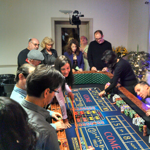 people gathered around a craps table